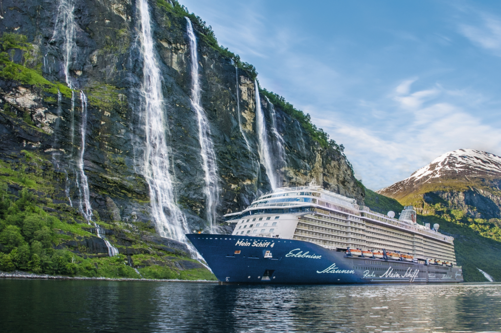 a cruise ship passing waterfalls